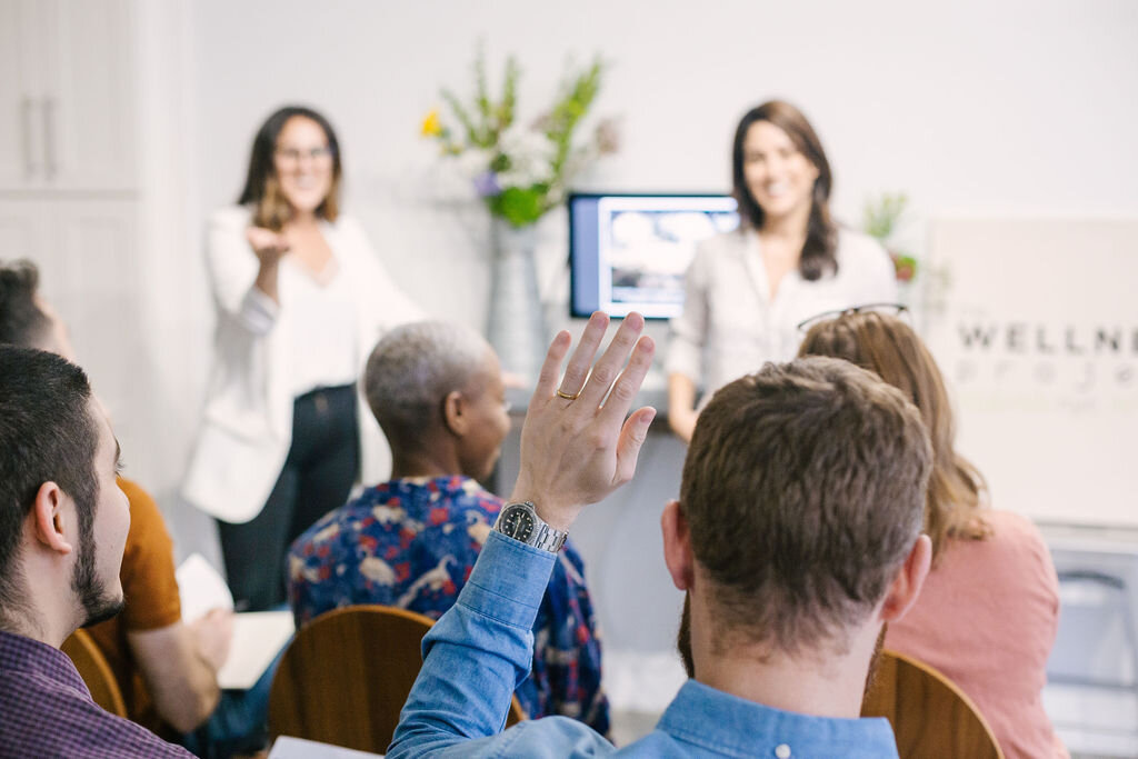 Picture of a seminar for health and well being. Seminars and workshops include educational classes and interactive team building events. 