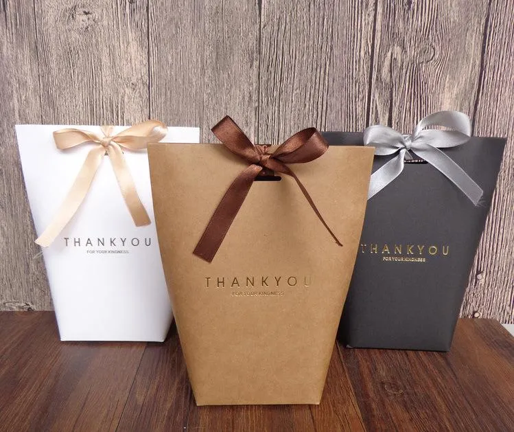 Assorted thank you gift bags filled with branded items, neatly arranged and ready for distribution. Each bag features a professional design, offering a thoughtful gesture of appreciation.