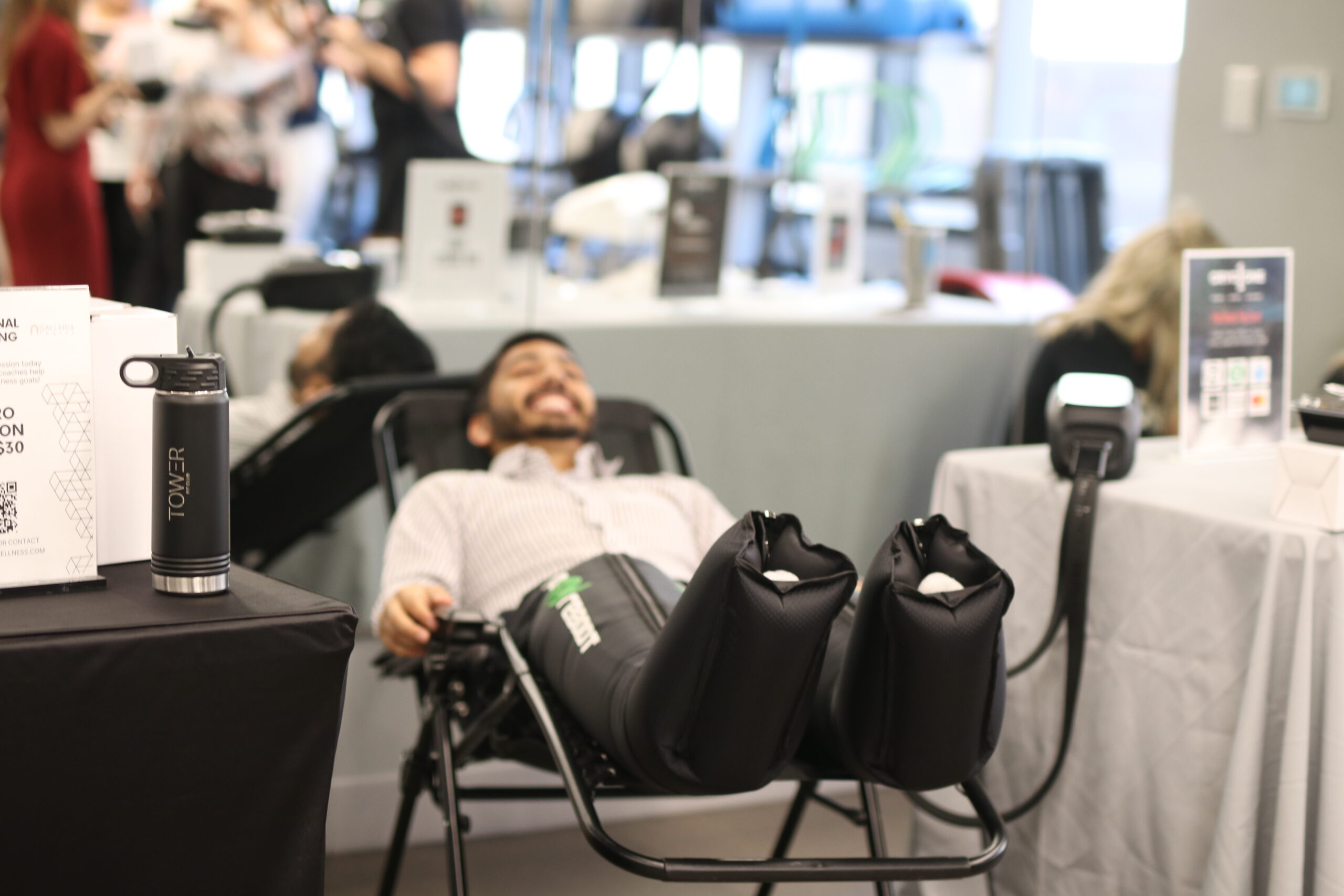 A tenant enjoying the Normatec compression therapy leggings at our corporate wellness event